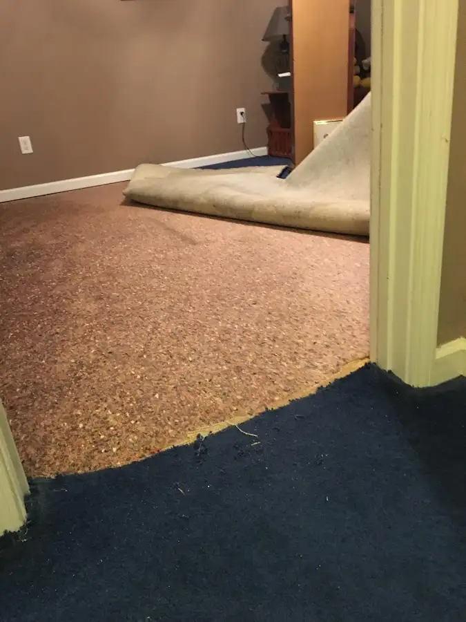 Carpet pad removal revealing water damage during Water Mitigation Services in Pemberton